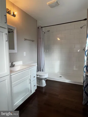 a white toilet sitting next to a bath tub