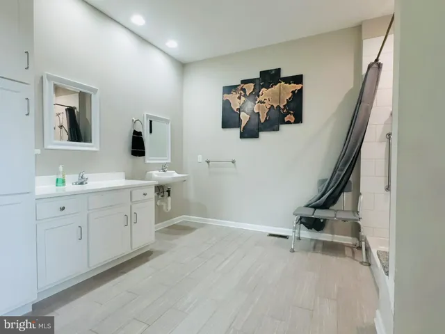 a view with a bathroom with a sink mirror and window