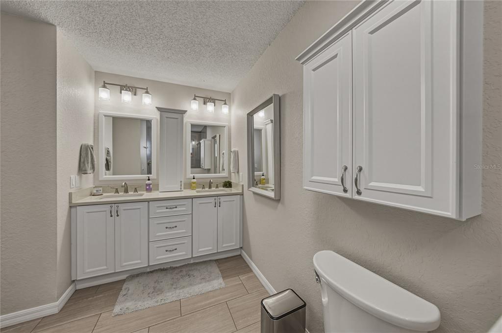 7435 Kilbride Court Weeki Wachee, FL 34613 - Photo 40 of 67 a bathroom with a toilet a sink and mirror