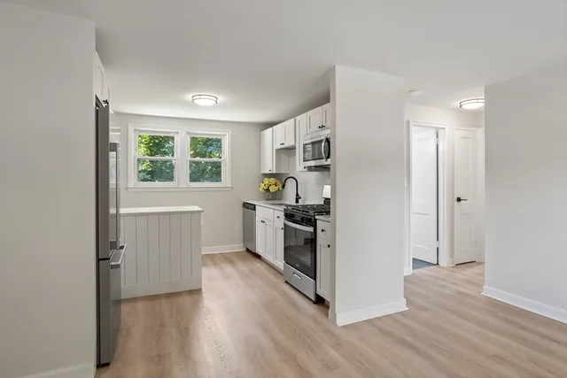 a kitchen with a refrigerator and window