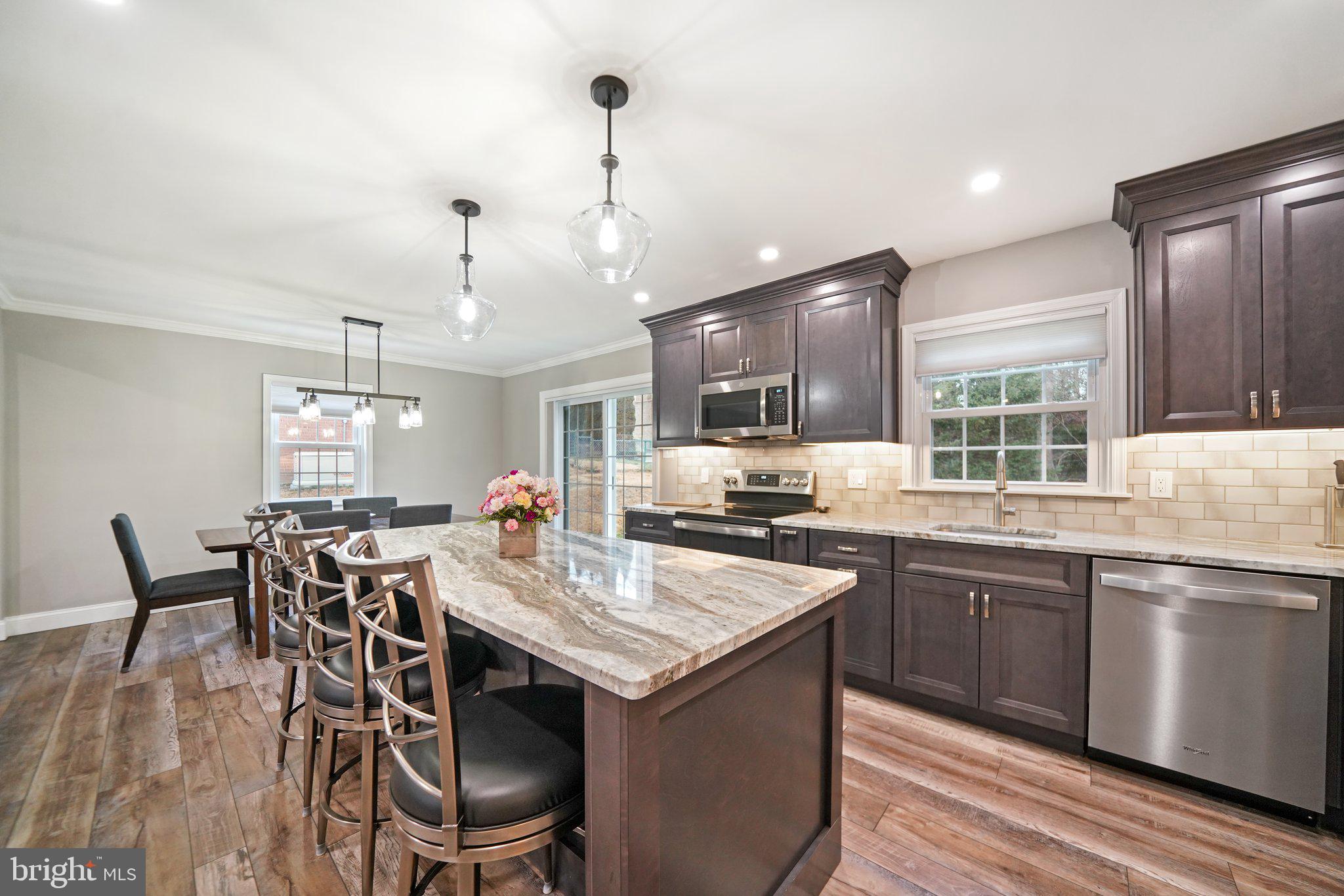 487 Kerr Lane Springfield, PA 19064 - Photo 11 of 48 a kitchen with center island table and chairs in it