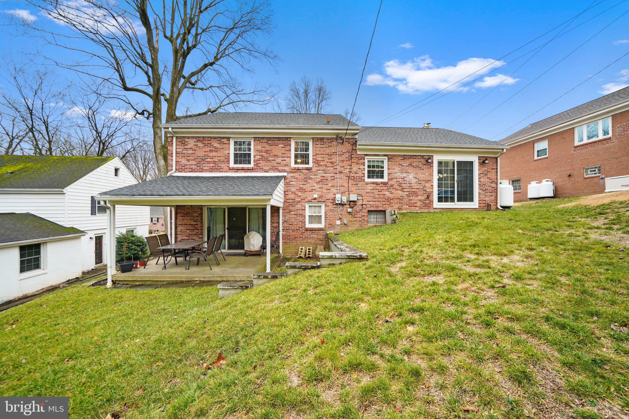487 Kerr Lane Springfield, PA 19064 - Photo 3 of 48 a front view of a house with a yard patio and fire pit