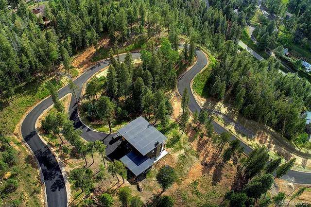 an aerial view of a house with swimming pool and outdoor space