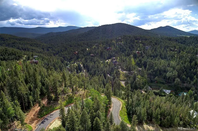 a view of a houses with a lush green hillside