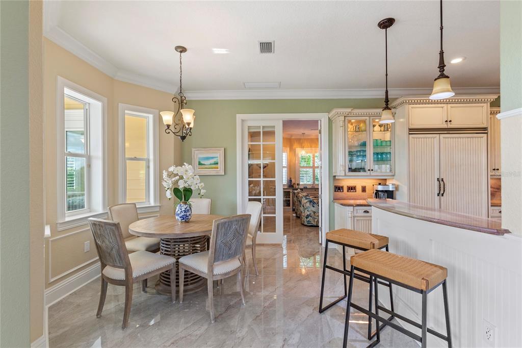 3523 West Shell Point Road Ruskin, FL 33570 - Photo 23 of 89 a dining room with furniture a chandelier and wooden floor