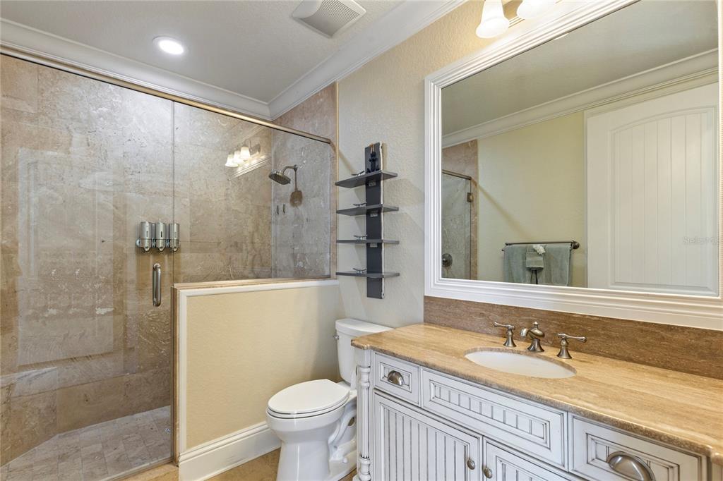 3523 West Shell Point Road Ruskin, FL 33570 - Photo 29 of 89 a bathroom with a granite countertop sink a toilet and shower