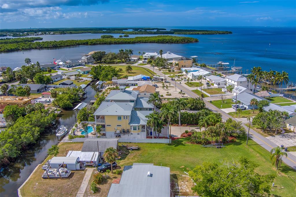 3523 West Shell Point Road Ruskin, FL 33570 - Photo 4 of 89 an aerial view of a house with a garden and lake view