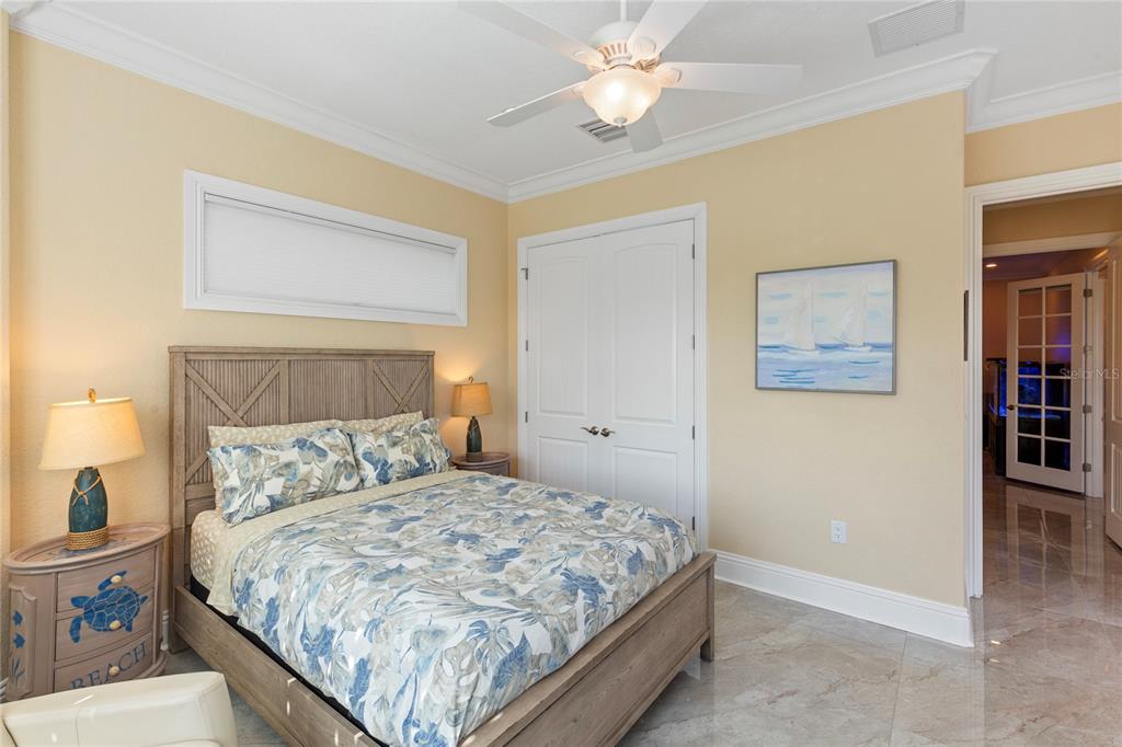 3523 West Shell Point Road Ruskin, FL 33570 - Photo 42 of 89 a bedroom with a bed and a chandelier
