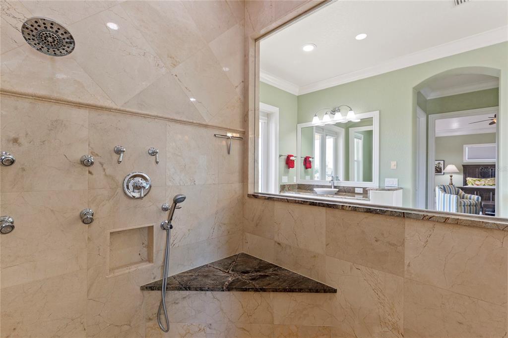 3523 West Shell Point Road Ruskin, FL 33570 - Photo 58 of 89 a bathroom with a granite countertop sink a mirror and shower
