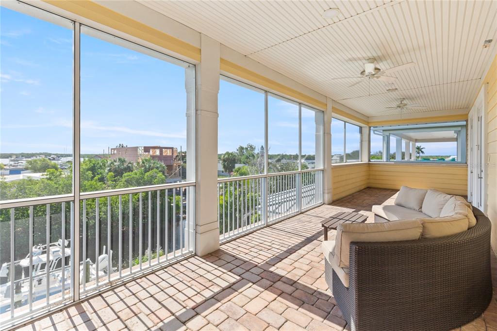 3523 West Shell Point Road Ruskin, FL 33570 - Photo 62 of 89 a bed sitting in a bedroom next to a large window