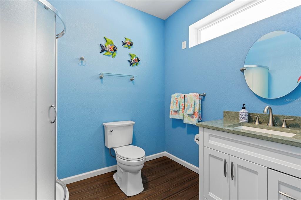 3523 West Shell Point Road Ruskin, FL 33570 - Photo 70 of 89 a bathroom with a toilet sink and mirror