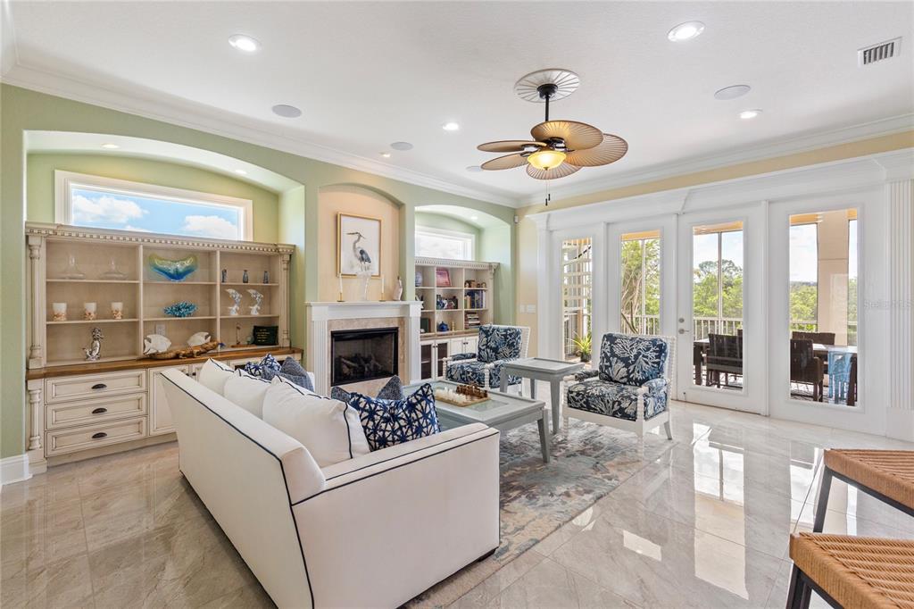 3523 West Shell Point Road Ruskin, FL 33570 - Photo 10 of 89 a living room with fireplace furniture and a large window