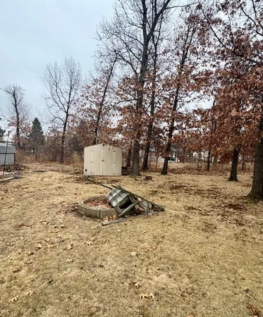 a backyard of a house with large trees and outdoor space