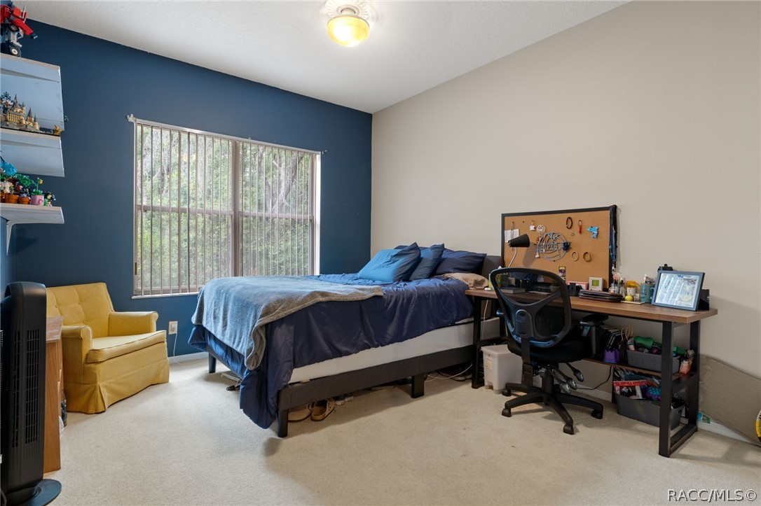 2460 West Pine Ridge Boulevard Beverly Hills, FL 34465 - Photo 33 of 47 a bedroom with a bed and a couch