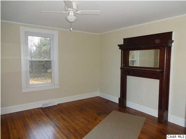 566 Half Mile Branch Road Crozet, VA 22932 - Photo 3 of 19 a view of empty room with wooden floor and fan