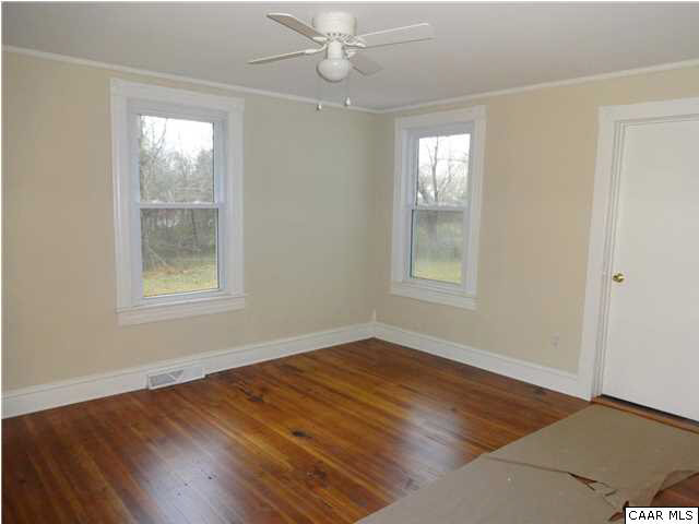 566 Half Mile Branch Road Crozet, VA 22932 - Photo 4 of 19 a view of an empty room with wooden floor and a window