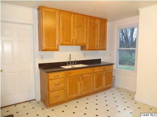566 Half Mile Branch Road Crozet, VA 22932 - Photo 7 of 19 a kitchen with granite countertop a sink and a stove next to a window