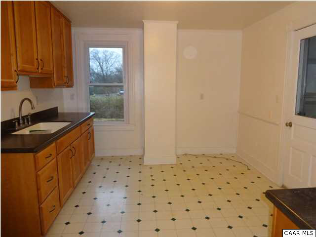 566 Half Mile Branch Road Crozet, VA 22932 - Photo 8 of 19 a kitchen with granite countertop a sink a stove a refrigerator and wooden cabinets