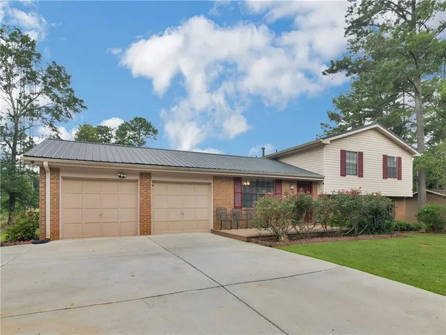 a front view of house along with trees