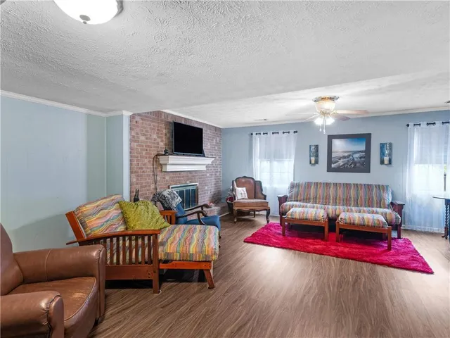 a living room with furniture fireplace and a window