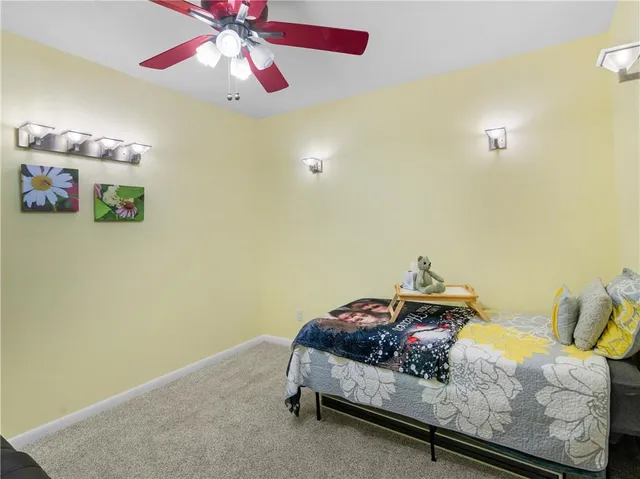 a bedroom with a bed and chandelier