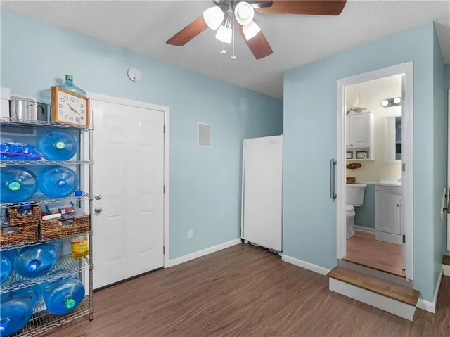 a view of an entryway with wooden floor