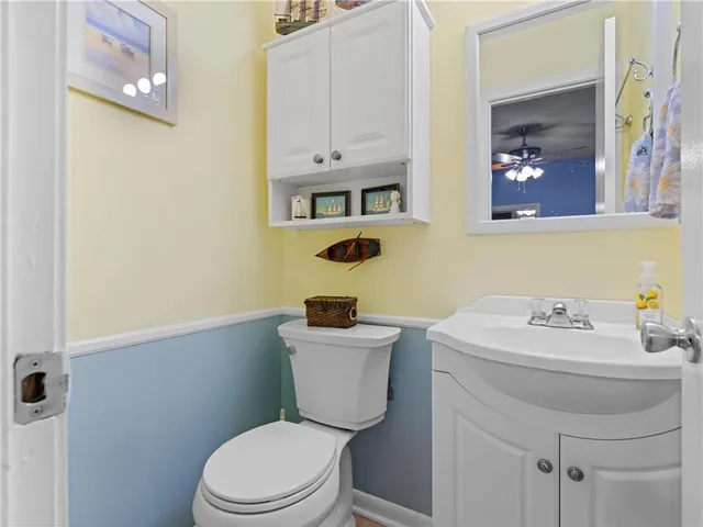 a bathroom with a sink toilet and mirror