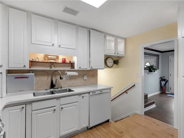 a kitchen with cabinets a sink and appliances