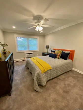 a bed room with a bed and a chandelier