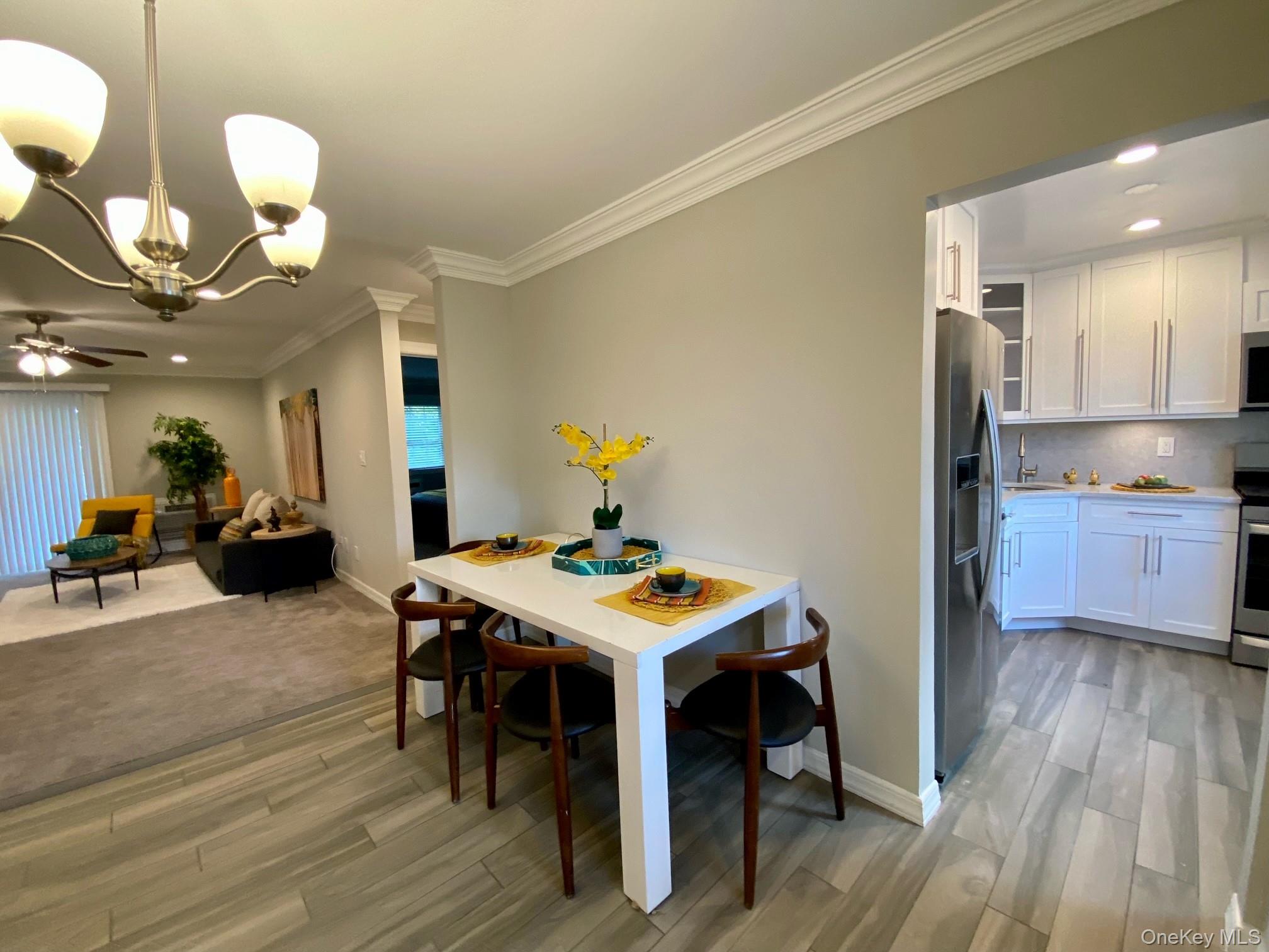 208 Terrace Road, Unit T04208 Bayport, NY 11705 - Photo 5 of 14 a view of a dining room with furniture and wooden floor