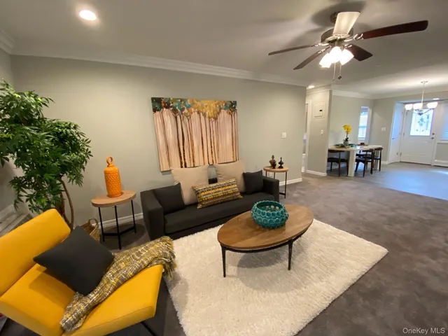 a living room with furniture a rug and a chandelier