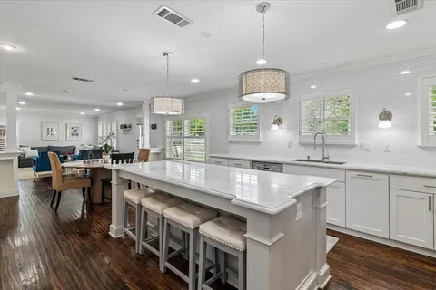 a large kitchen with lots of counter space a sink appliances and a window