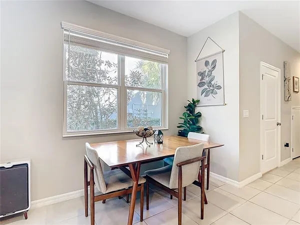 a dining room with furniture and window