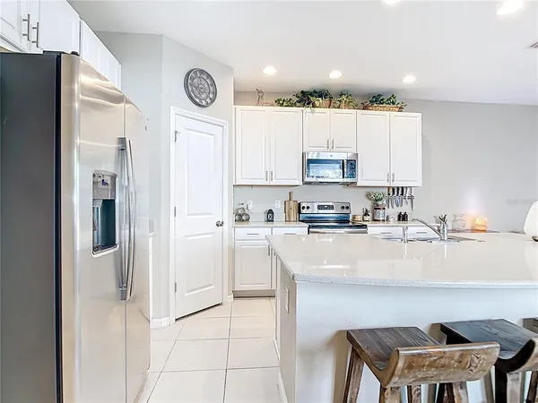 a kitchen with a refrigerator a stove a sink and a cabinets