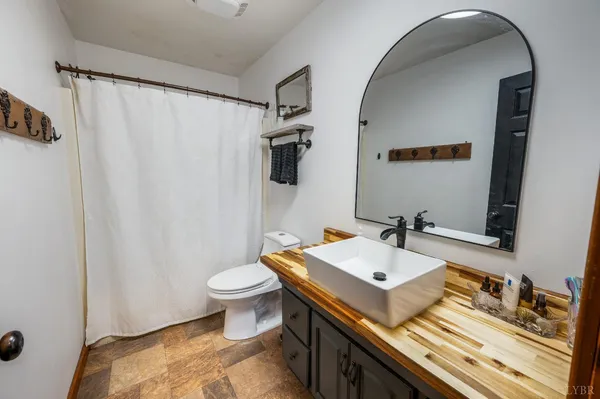 a bathroom with a sink a toilet and vanity