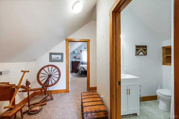 a bedroom with a bed a dresser and a flat screen tv