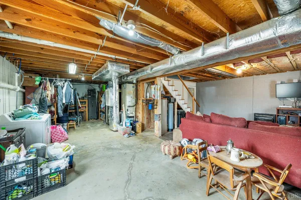 a backyard of a house with table and chairs