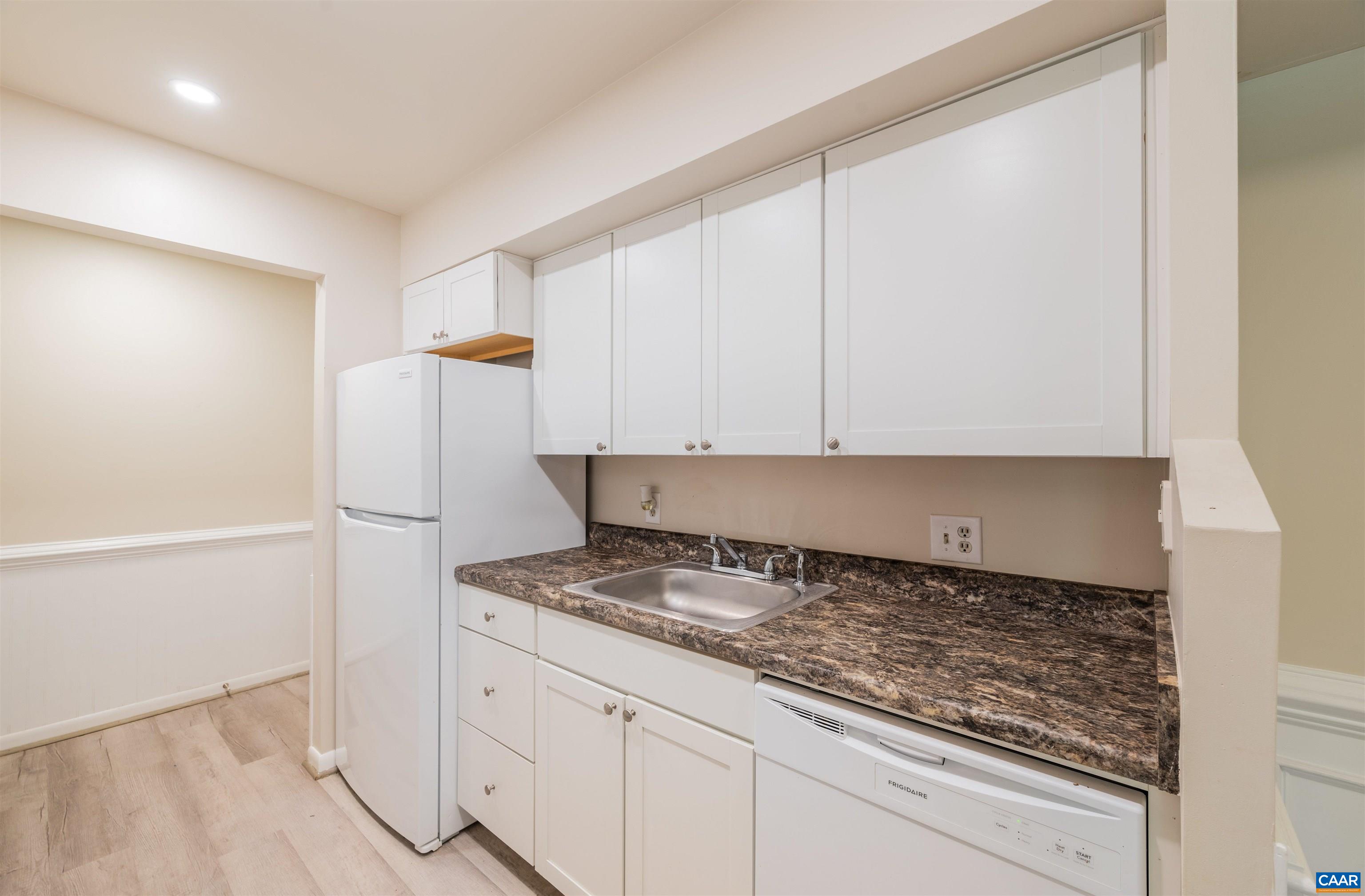 109 Turtle Creek Road, Unit 2 Charlottesville, VA 22901 - Photo 16 of 32 a kitchen with granite countertop white cabinets and white appliances
