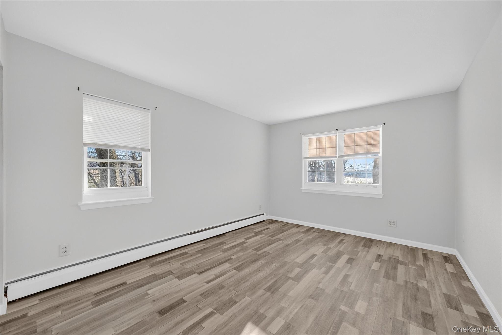 4 Colonial Road, Unit 96 Beacon, NY 12508 - Photo 13 of 17 a view of an empty room with wooden floor and a window