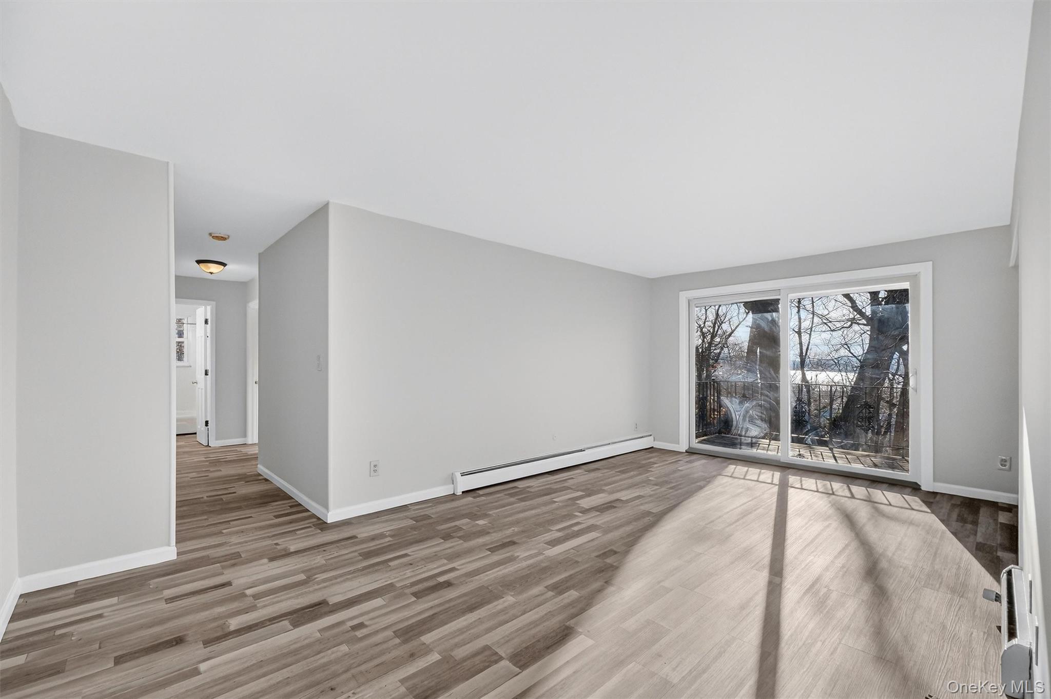 4 Colonial Road, Unit 96 Beacon, NY 12508 - Photo 4 of 17 a view of an empty room with wooden floor and a window