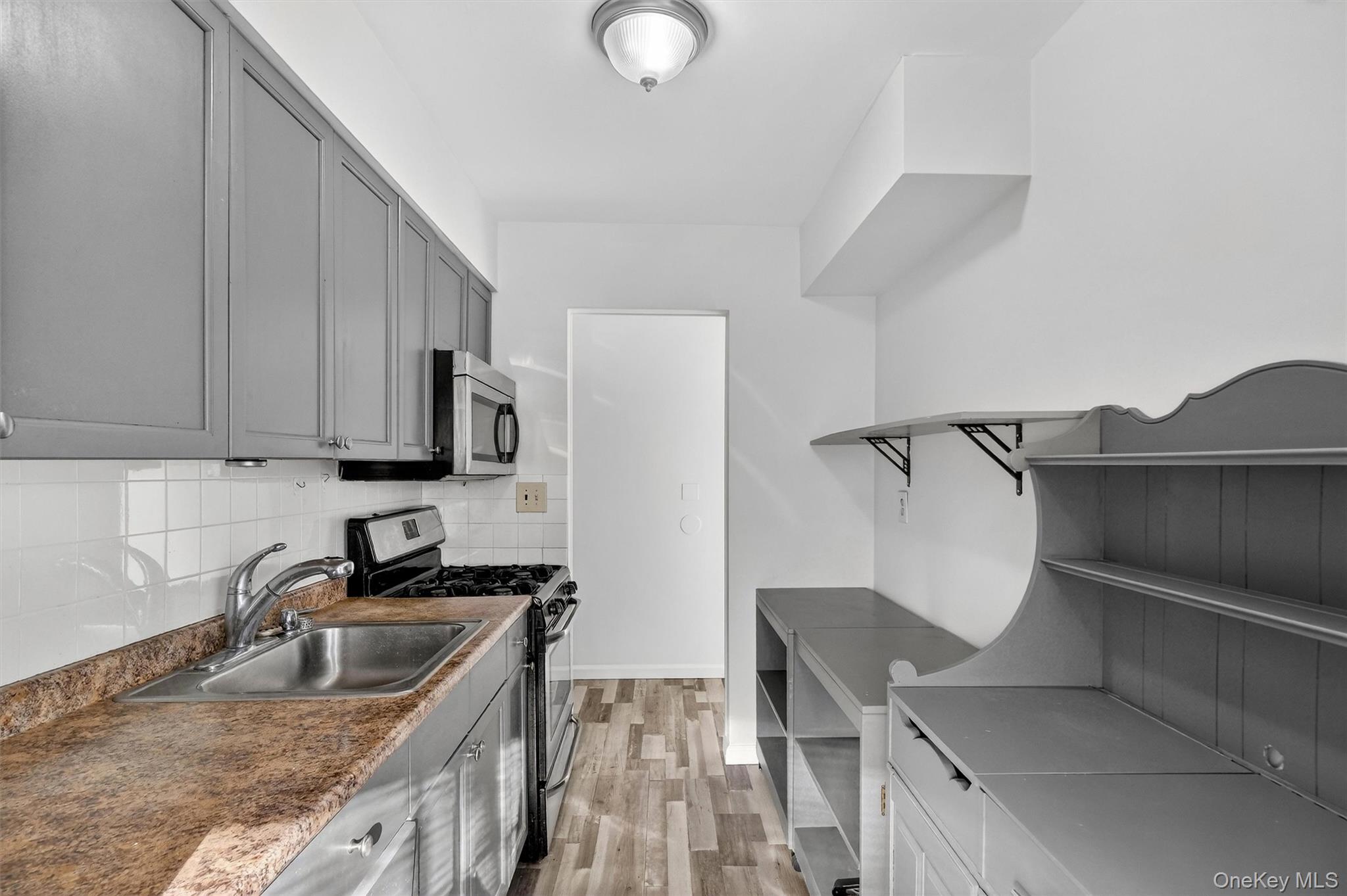 4 Colonial Road, Unit 96 Beacon, NY 12508 - Photo 10 of 17 a kitchen with stainless steel appliances granite countertop a sink stove and refrigerator