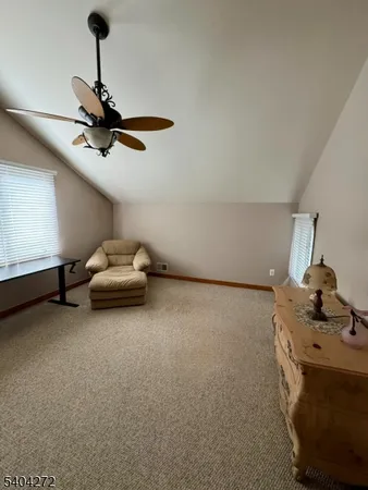 a living room with furniture and a ceiling fan