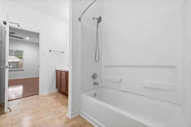 a bathroom with a tub and shower