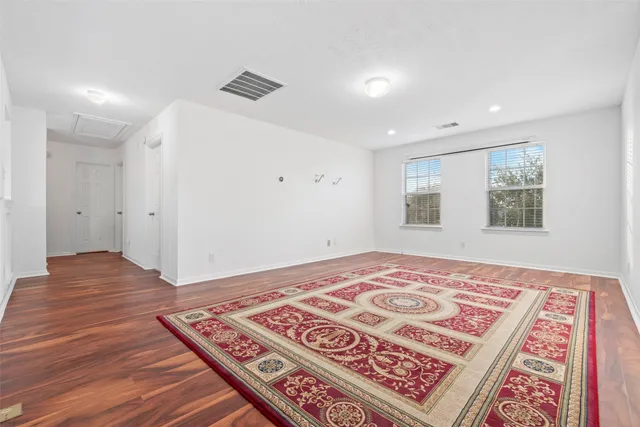 a bedroom with a bed and a rug