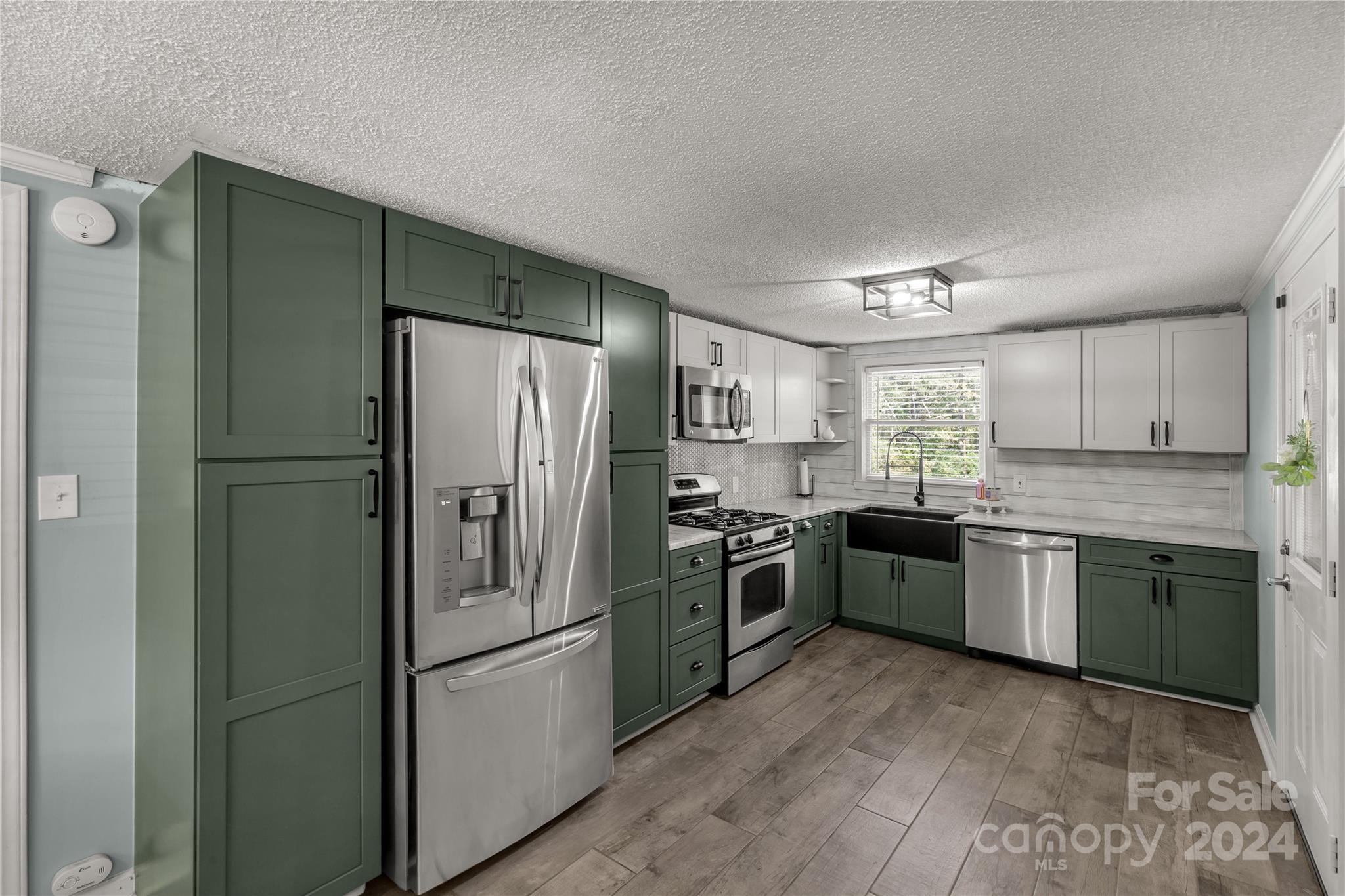 3593 Taxahaw Road Lancaster, SC 29720 - Photo 6 of 23 a kitchen with granite countertop stainless steel appliances and a refrigerator