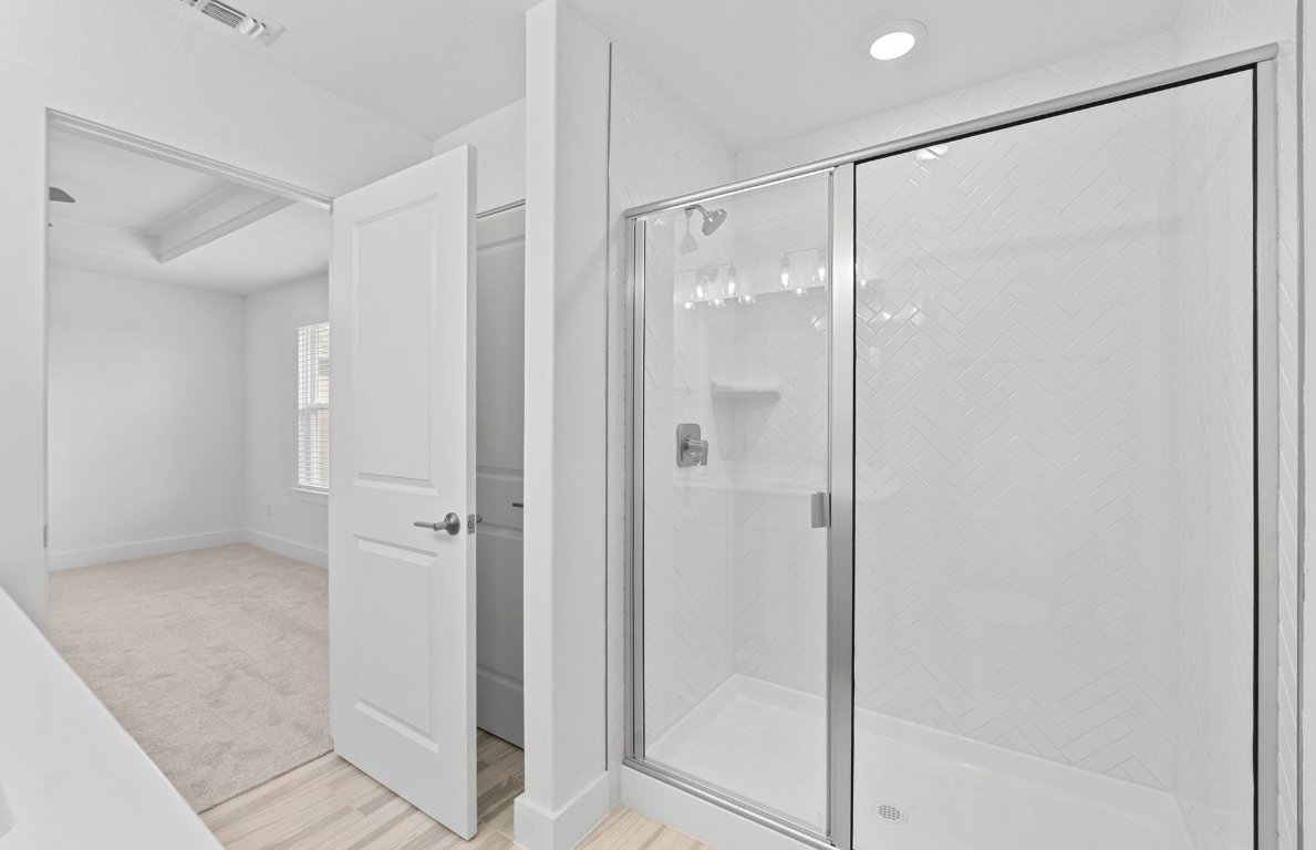 494 Tailwind Drive Kyle, TX 78640 - Photo 17 of 34 a bathroom with a glass shower door