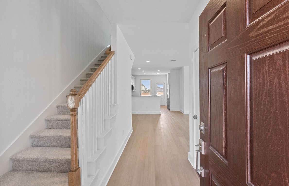 494 Tailwind Drive Kyle, TX 78640 - Photo 5 of 34 a view of a hallway with wooden floor and staircase