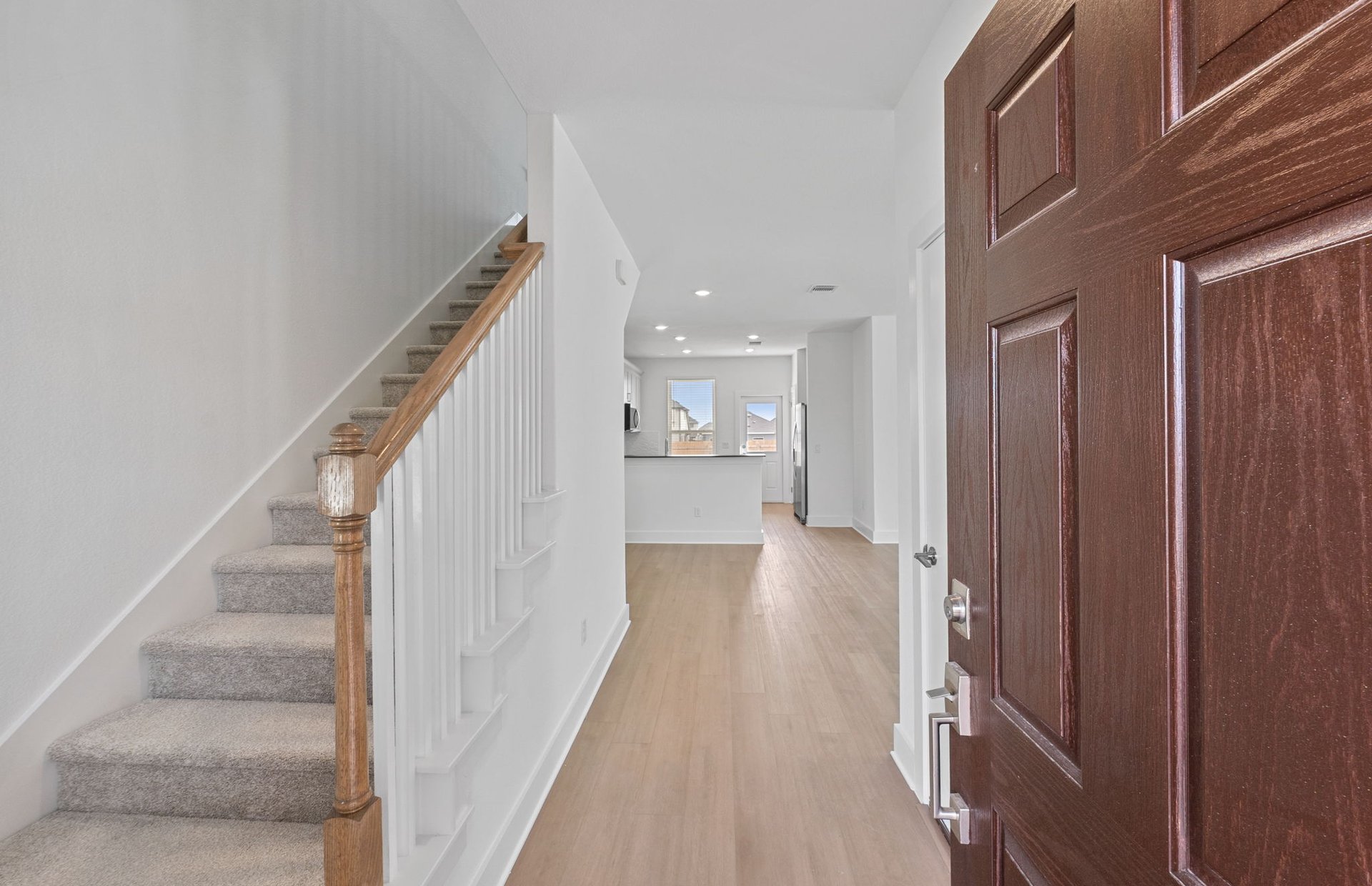 494 Tailwind Drive Kyle, TX 78640 - Photo 5 of 34 a view of a hallway with wooden floor and staircase