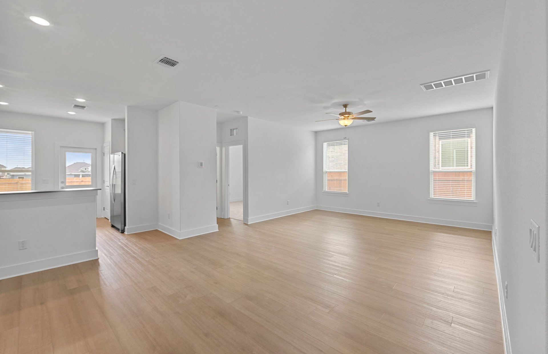 494 Tailwind Drive Kyle, TX 78640 - Photo 6 of 34 a view of an empty room with window and wooden floor