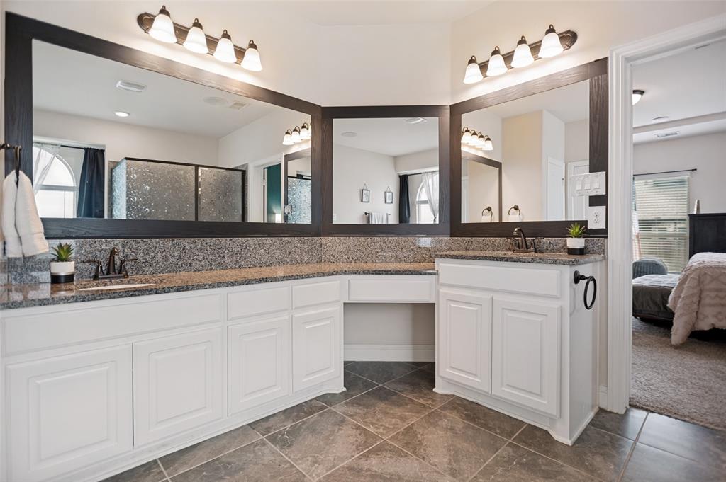 413 Frontier Court Midlothian, TX 76065 - Photo 18 of 26 Dual vanity with integrated sinks and dark bronze fixtures, framed mirrors, and granite countertops